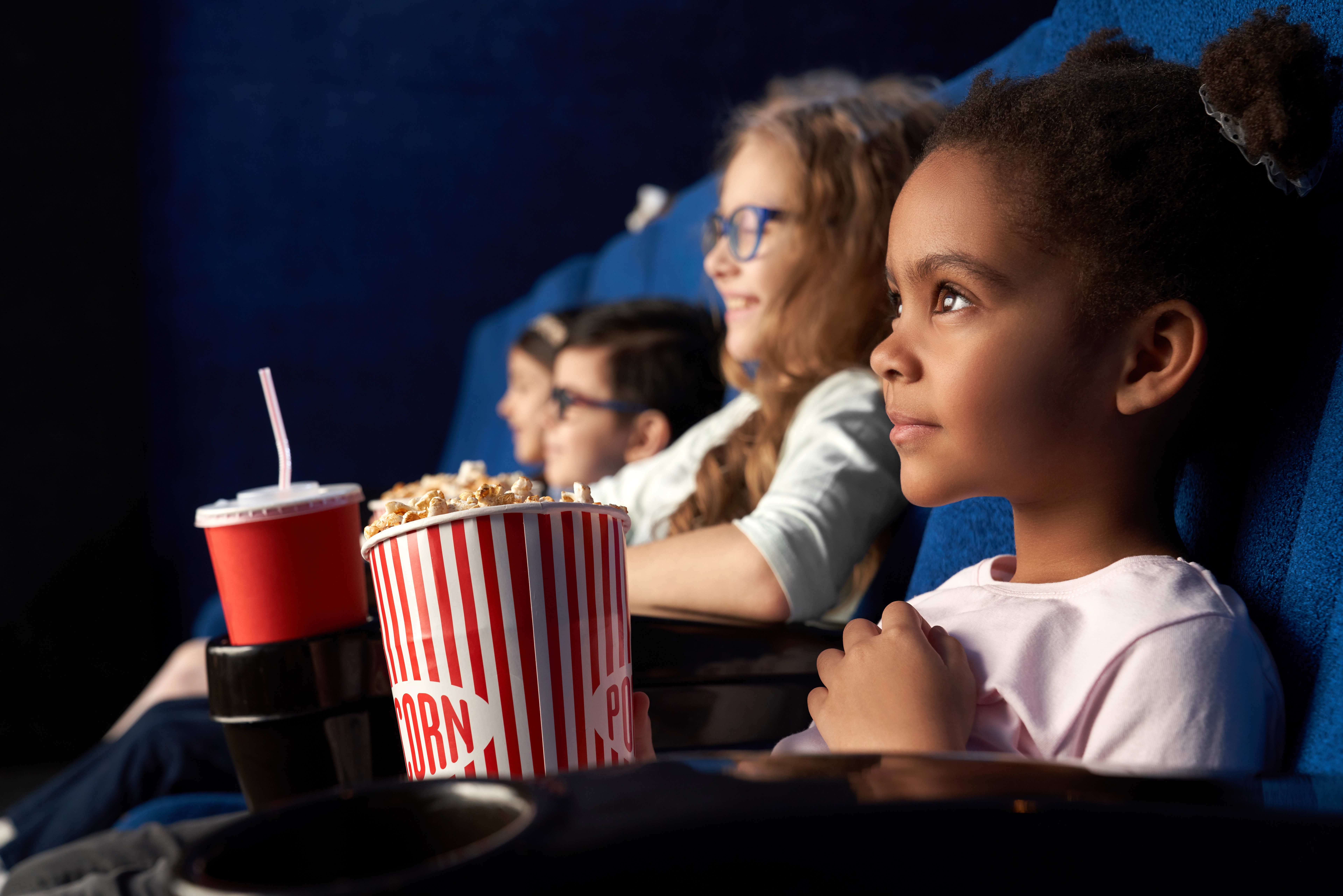 beautiful-african-girl-with-funny-hairstyle-watching-movie-in-cinema